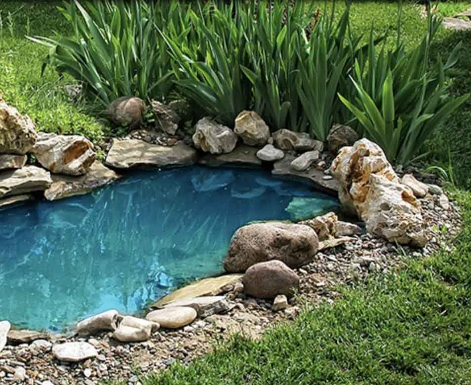 A pond being installed in a backyard