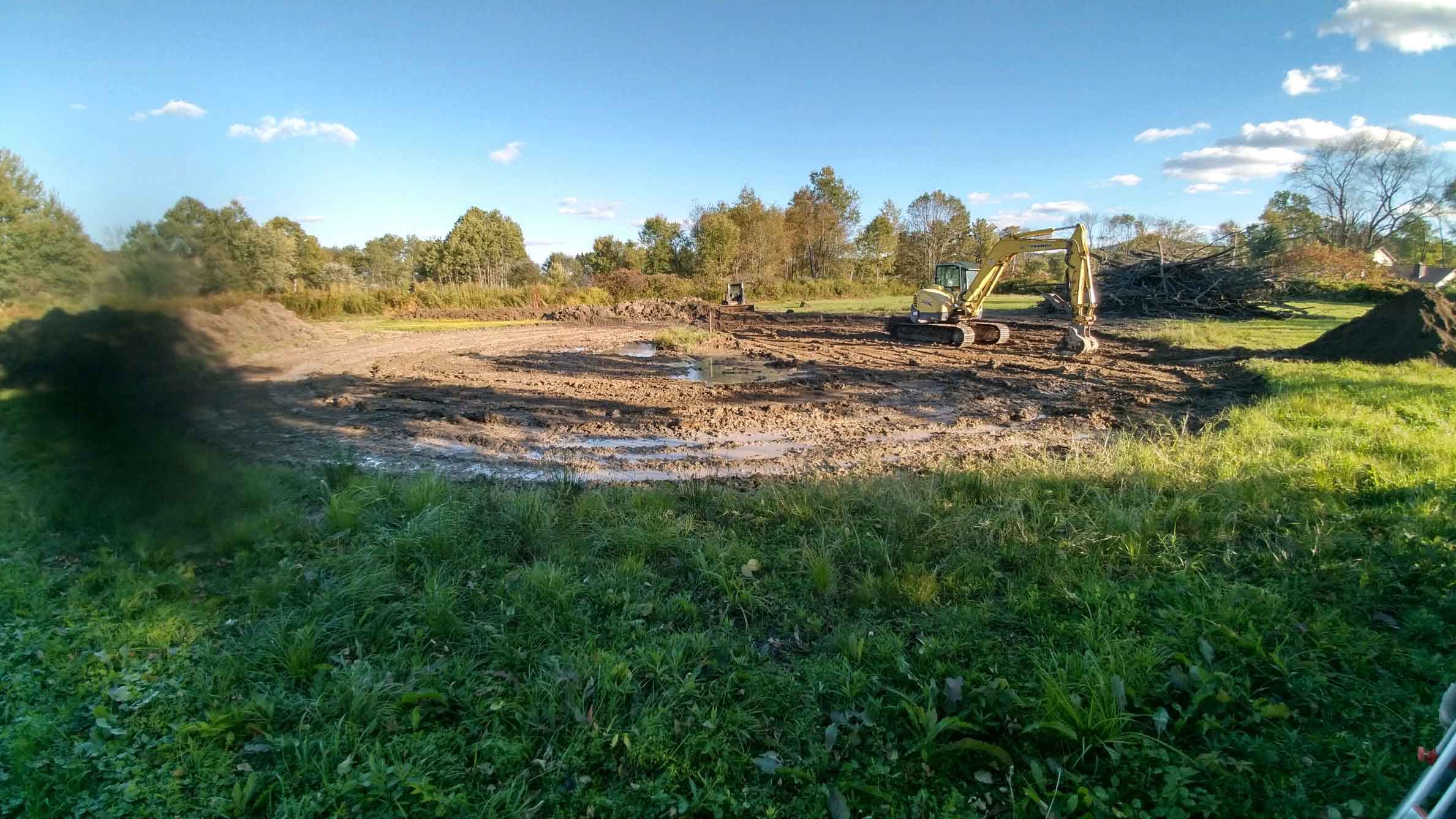 A construction vehicle prepping the area for construction
